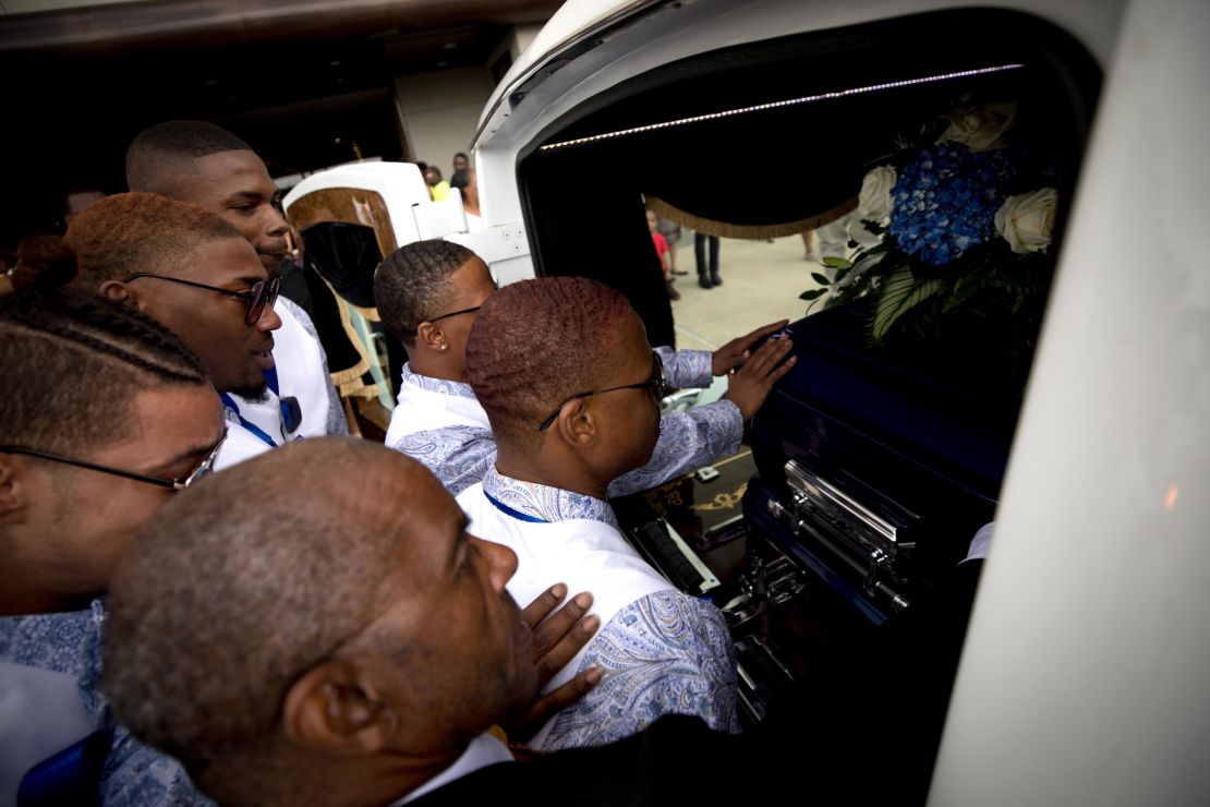 Muhlaysia Booker's friends say a final goodbye to her casket after her funeral service in May 2019.