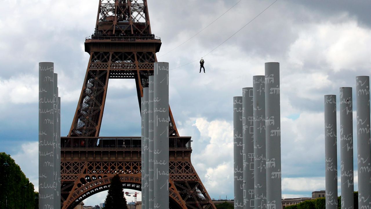A person rides a zip line from the second floor of the Eiffel Tower in Paris on Tuesday, May 28.