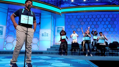 Rohan Raja, 13, of Irving, Texas, spells the last word in competition as the remaining competitors celebrate an eight-way tie.