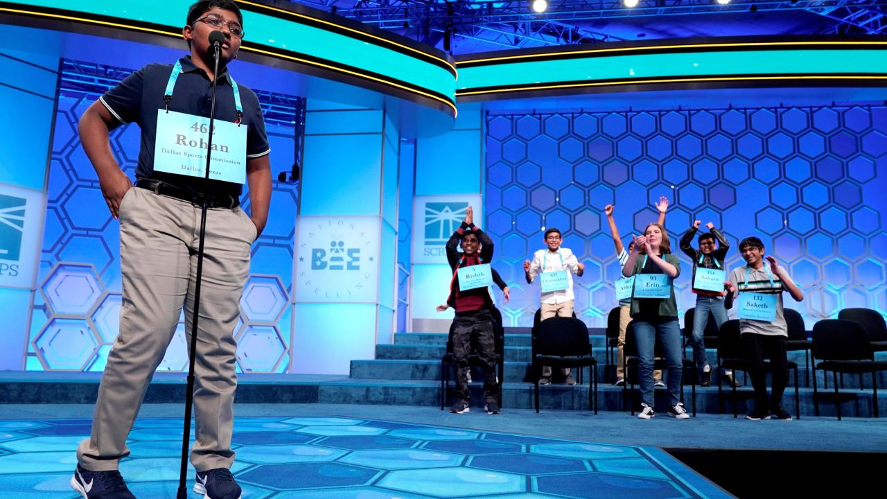 Rohan Raja, 13, of Irving, Texas, spells the last word in competition as the remaining competitors celebrate an eight-way tie.