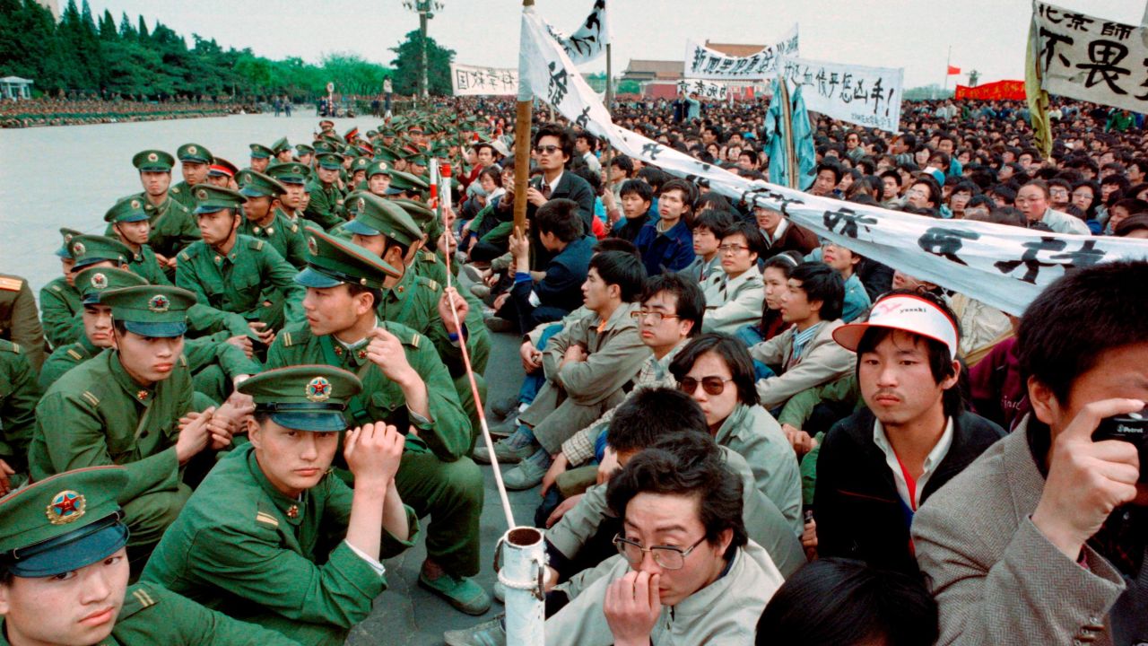 Hundreds of pro-democracy student protesters sit face-to-face with soldiers in  Tiananmen Square, Beijing on April 22, 1989.