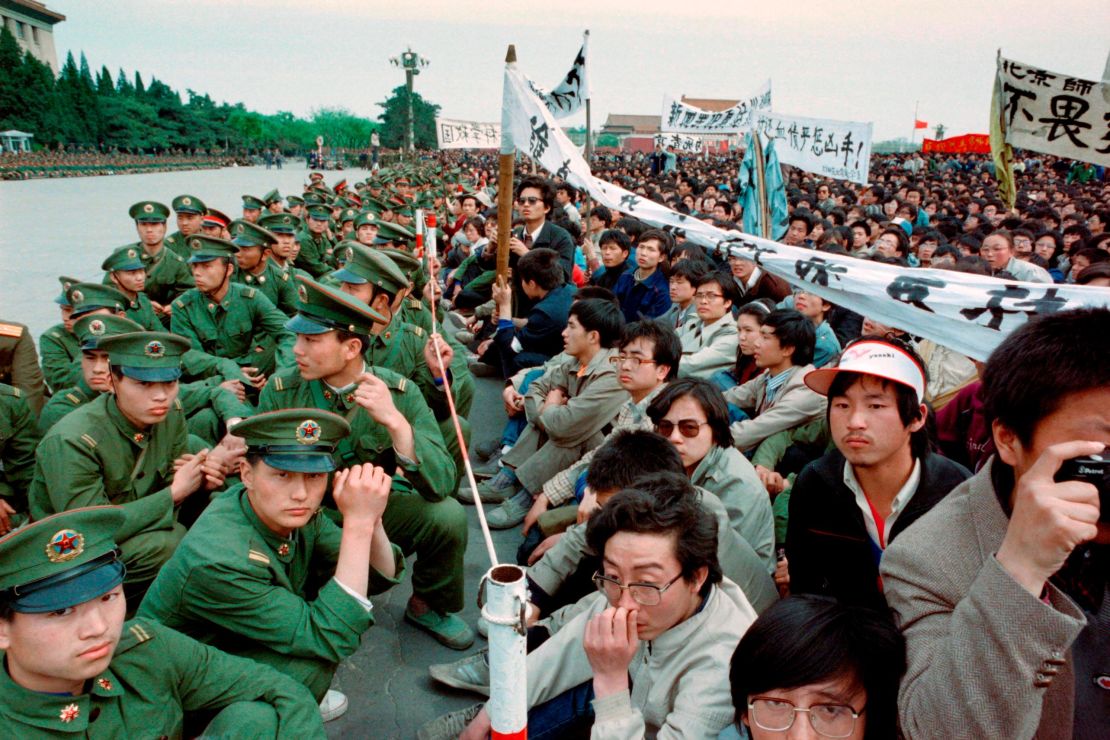 Hundreds of pro-democracy student protesters sit face-to-face with soldiers in  Tiananmen Square, Beijing on April 22, 1989.
