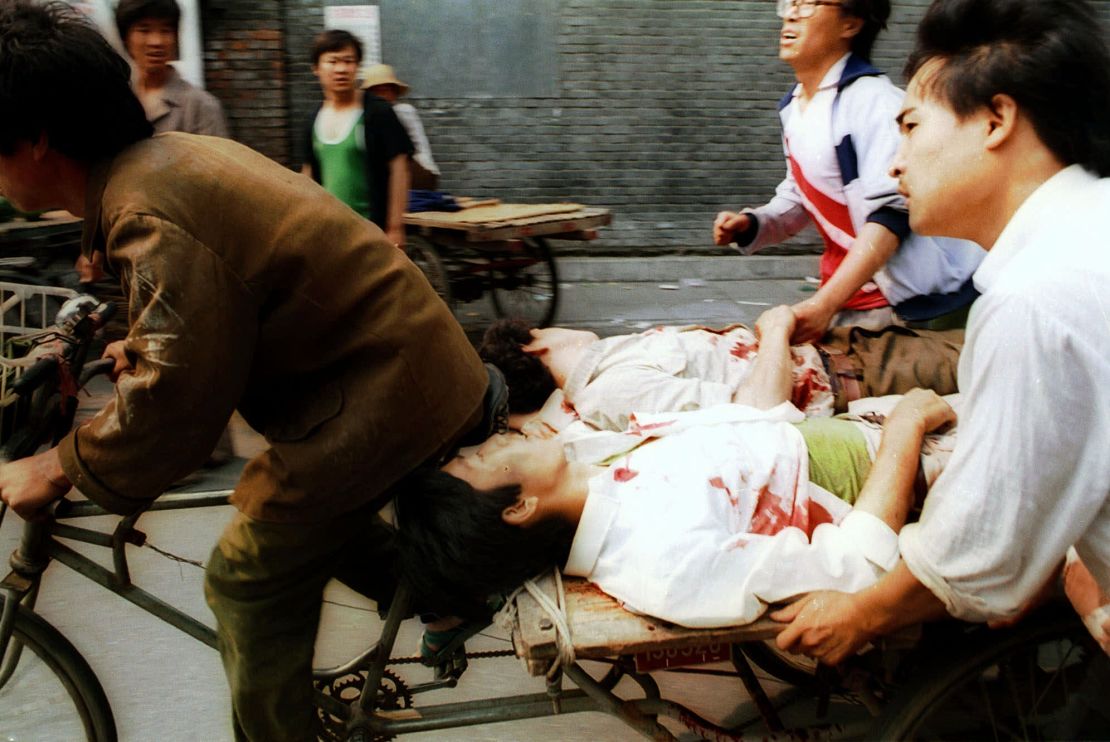 On June 4, a rickshaw driver pedals wounded people, with the help of bystanders, to a nearby hospital in Beijing after they were injured during clashes with Chinese soldiers in Tiananmen Square.