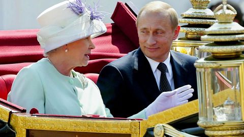 Putin and the Queen share an open carriage along the Mall following his arrival in London in 2003.