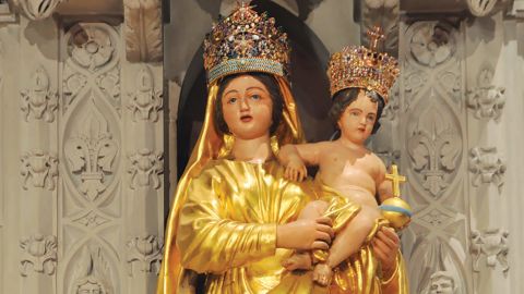 Mary draped in gold serves as an intercessor.