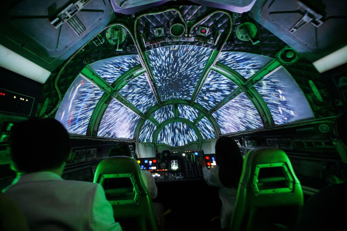 Guests sit in the Millennium Falcon: Smugglers Run ride.