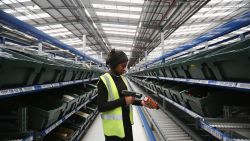 MILTON KEYNES, ENGLAND - JANUARY 03: A worker scans an item in the giant semi-automated distribution centre where the company's partners process the online orders for the John Lewis department store on January 3, 2013 in Milton Keynes, England. John Lewis has published their sales report for the five weeks prior December 29, 2012 which showed online sales had increased by 44.3 per cent over the same period in 2011. Purchases from their website Johnlewis.com now account for one quarter of all John Lewis business.  (Photo by Oli Scarff/Getty Images)