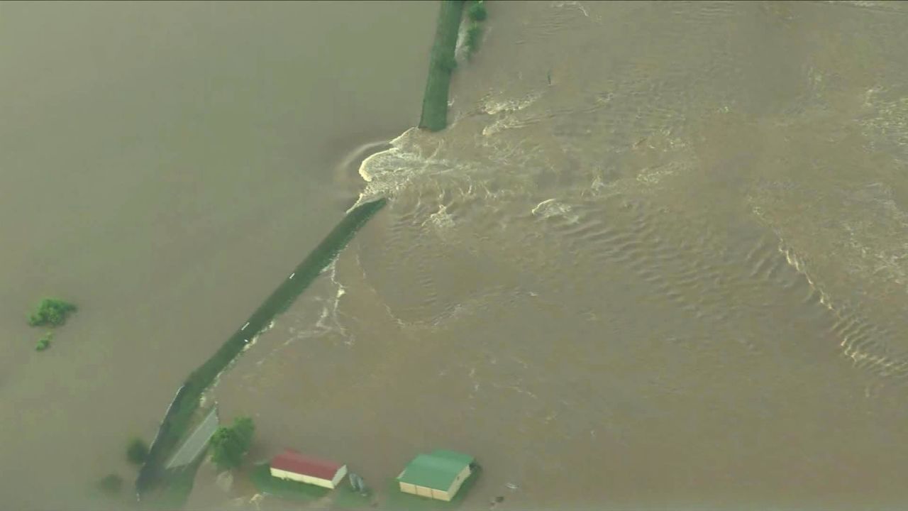 Water gushes past a breach in an Arkansas River levee Friday near Dardanelle,  Arkansas.