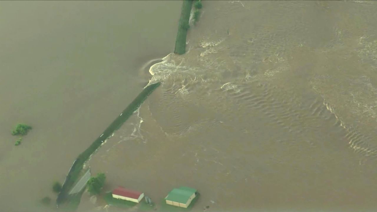 Water gushes past a breach in an Arkansas River levee Friday near Dardanelle, Arkansas.