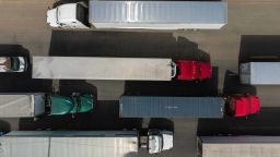 Aerial view of cargo trucks heading to the United States lining up near the commercial port of entry in Otay, in Tijuana, Baja California state on May 30, 2019. - Washington will impose a five percent tariff on all goods from Mexico starting June 10, a measure that will last until "illegal migrants" stop coming through the country into the US, President Donald Trump said Thursday. (Photo by Guillermo Arias / AFP)        (Photo credit should read GUILLERMO ARIAS/AFP/Getty Images)