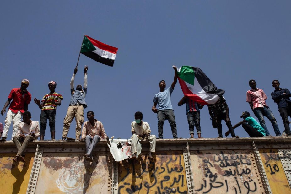 Protesters wave national flags at a sit-in outside the military headquarters in Khartoum on May 2.