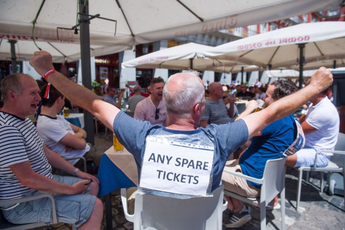 A fan struggles to find tickets for the UEFA Champions League Final at the Plaza Mayor square in Madrid.