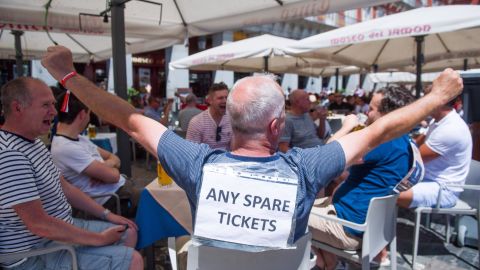 A fan struggles to find tickets for the UEFA Champions League Final at the Plaza Mayor square in Madrid.