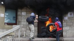 Protesters add tires to a fire outside the main entrance into the U.S. Embassy during a protest against the government of President Juan Orlando Hernandez, in Tegucigalpa, Honduras, Friday, May 31, 2019. 