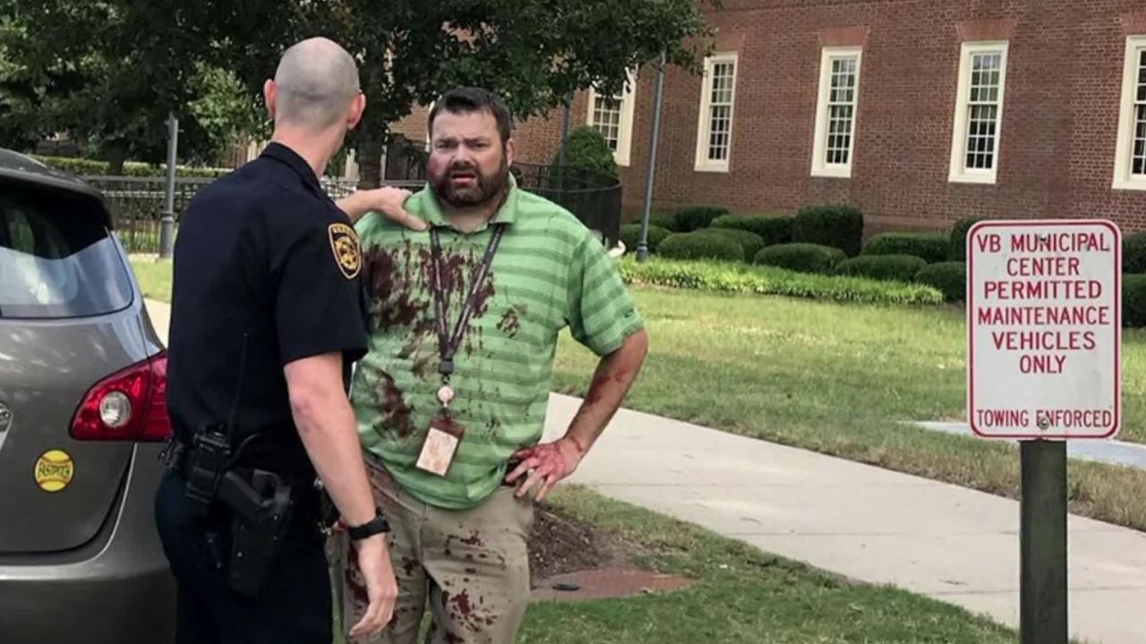 Alyssa Andrews took a photo of a man with a bloodied shirt outside the municipal building in Virginia Beach. The man's identity and his condition were not immediately known.