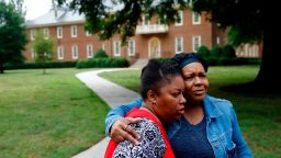 Shelia Cook, left, and Renee Russell, members of Mount Olive Baptist Church, embrace after praying near a municipal building that was the scene of a shooting, Saturday, June 1, 2019, in Virginia Beach, Va. A longtime city employee opened fire at the building Friday before police shot and killed him, authorities said. (AP Photo/Patrick Semansky)