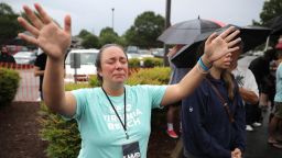 VIRGINIA BEACH, VIRGINIA - JUNE 01: People gather for a public prayer service organized by Lifehouse Virginia Beach in the parking lot of a shopping center the day after a mass shooting left 13 people dead June 01, 2019 in Virginia Beach, Virginia. The names of the 12 victims of Friday's shooting rampage at the city's Municipal Center were made public along with the identity of the shooter, city engineer DeWayne Craddock. (Photo by Chip Somodevilla/Getty Images)