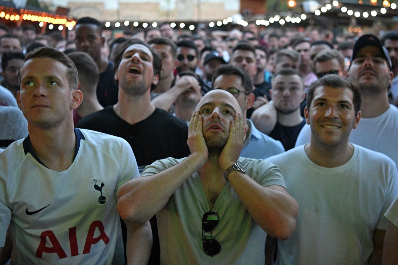 Tottenham supporters in Flat Iron Square in London react as they watch the final. 