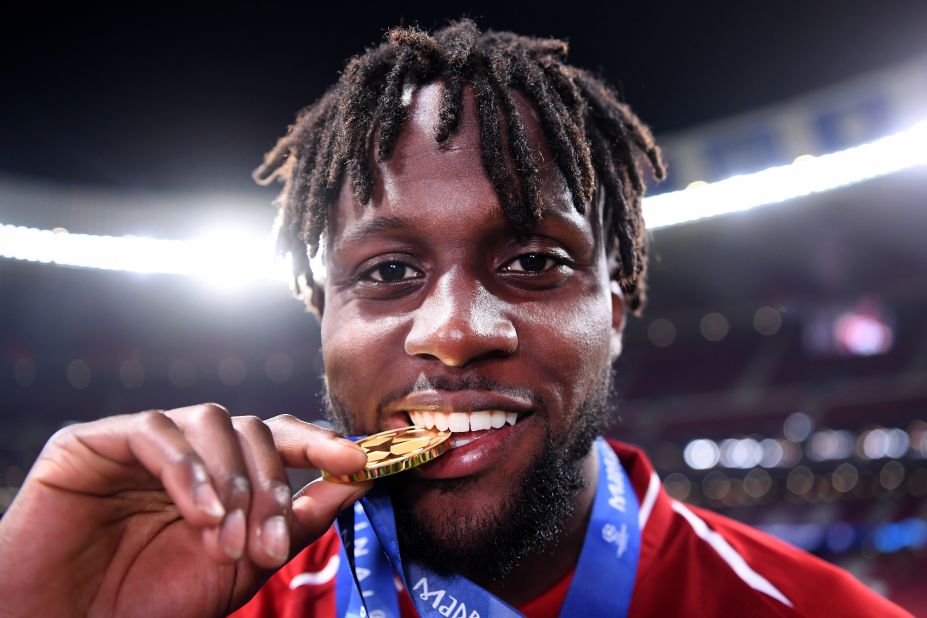 Divock Origi of Liverpool -- who came on to score the second goal -- celebrates with his medal after the match. 