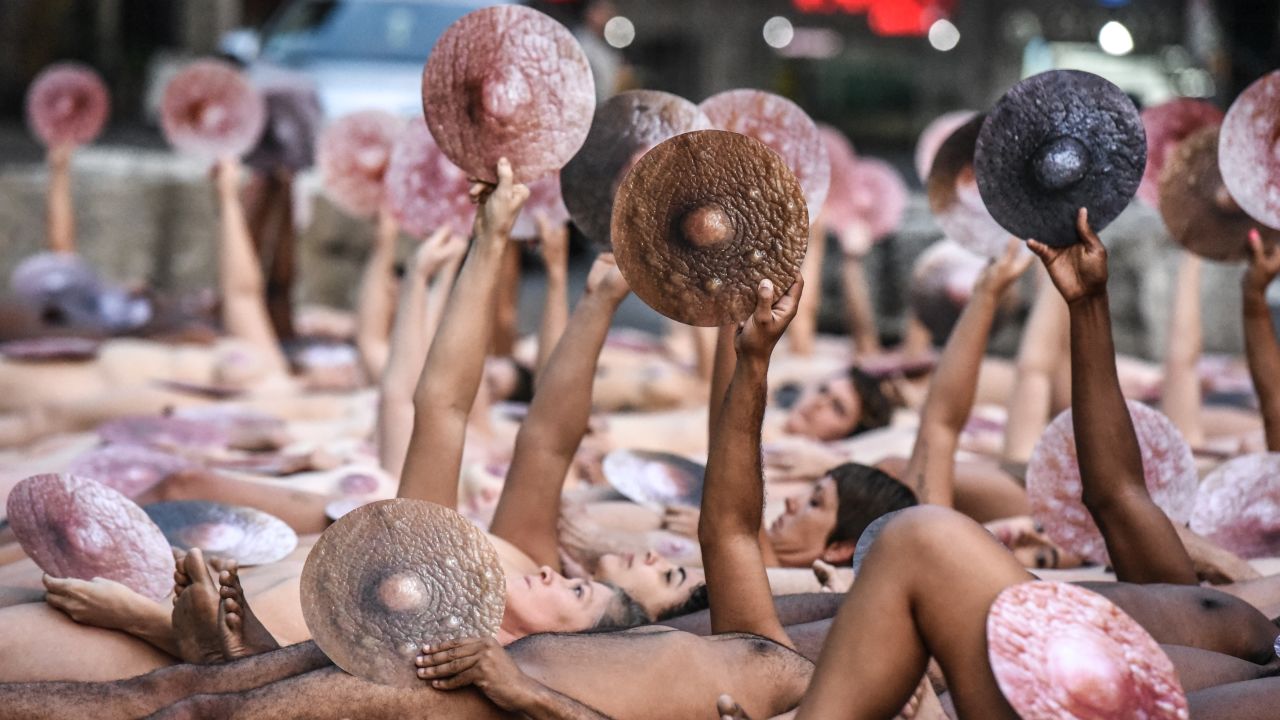 NEW YORK, NY - JUNE 02: (EDITOR'S NOTE: This image contains partial nudity) People pose nude holding cut outs of nipples during a photo shoot by artist Spencer Tunick on June 2, 2019 in New York City. Spencer Tunick staged his photo shoot in front of the Facebook building in Manhattan to protest Facebook and Instagram's ban on showing the female nipple on their social media platforms. Tunic says that the ban hurts fine artists who use nudity in  their artwork. (Photo by Stephanie Keith/Getty Images)