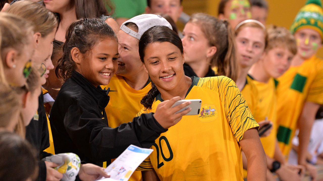 Kerr poses with a fan after the 2019 Cup of Nations match between Australia and South Korea in Brisbane, Australia.