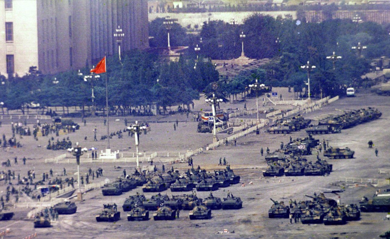 Chinese troops and tanks gather in Beijing, one day after the military crackdown.