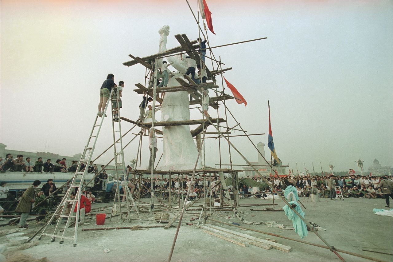 Students artists apply finishing touches to the "Goddess of Democracy" statue in Tiananmen Square on May 30, 1989.