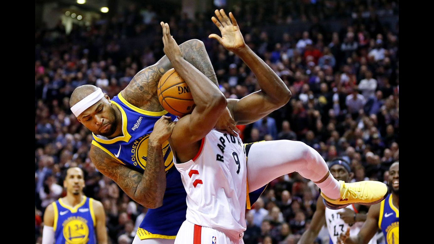Golden State Warriors center DeMarcus Cousins, left, fouls Toronto Raptors center Serge Ibaka during the fourth quarter of Game 1 of the NBA Finals at Scotiabank Arena in Toronto on Thursday, May 30. Toronto won the game 118-109 to take a lead in the series against the defending champions.
