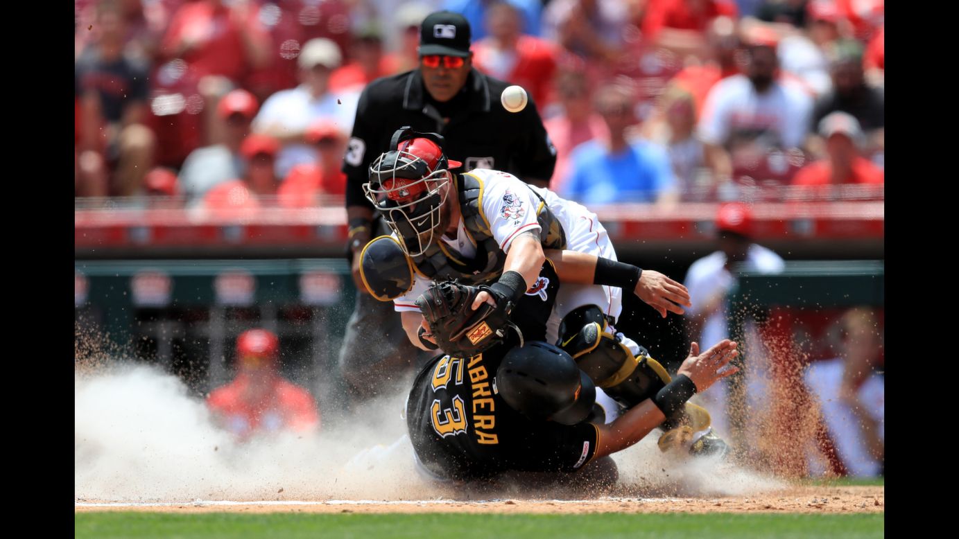 Pittsburgh Pirates right fielder Melky Cabrera collides at home plate with Cincinnati Reds catcher Tucker Barnhart to score a run during the fourth inning of their game at Great American Ballpark in Cincinnati on Monday, May 27.