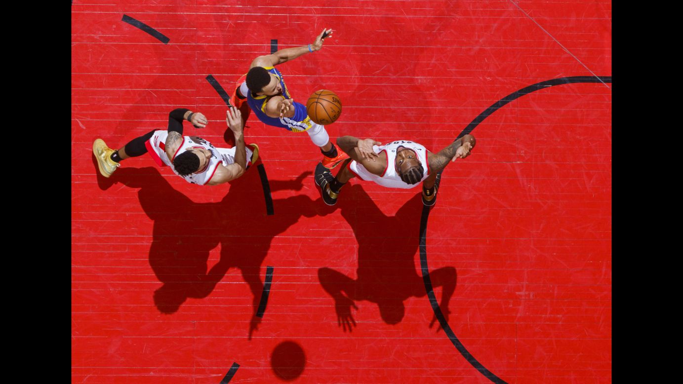 Stephen Curry of the Golden State Warriors shoots over Kawhi Leonard of the Toronto Raptors during Game 1 of the NBA Finals at Scotiabank Arena in Toronto on May 30.