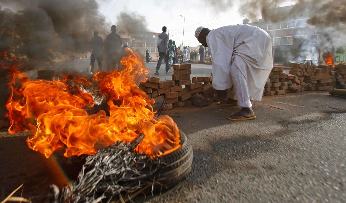 Sudanese protesters close Street 60 with burning tyres and pavers as military forces tried to disperse the sit-in outside Khartoum's army headquarters on June 3, 2019.