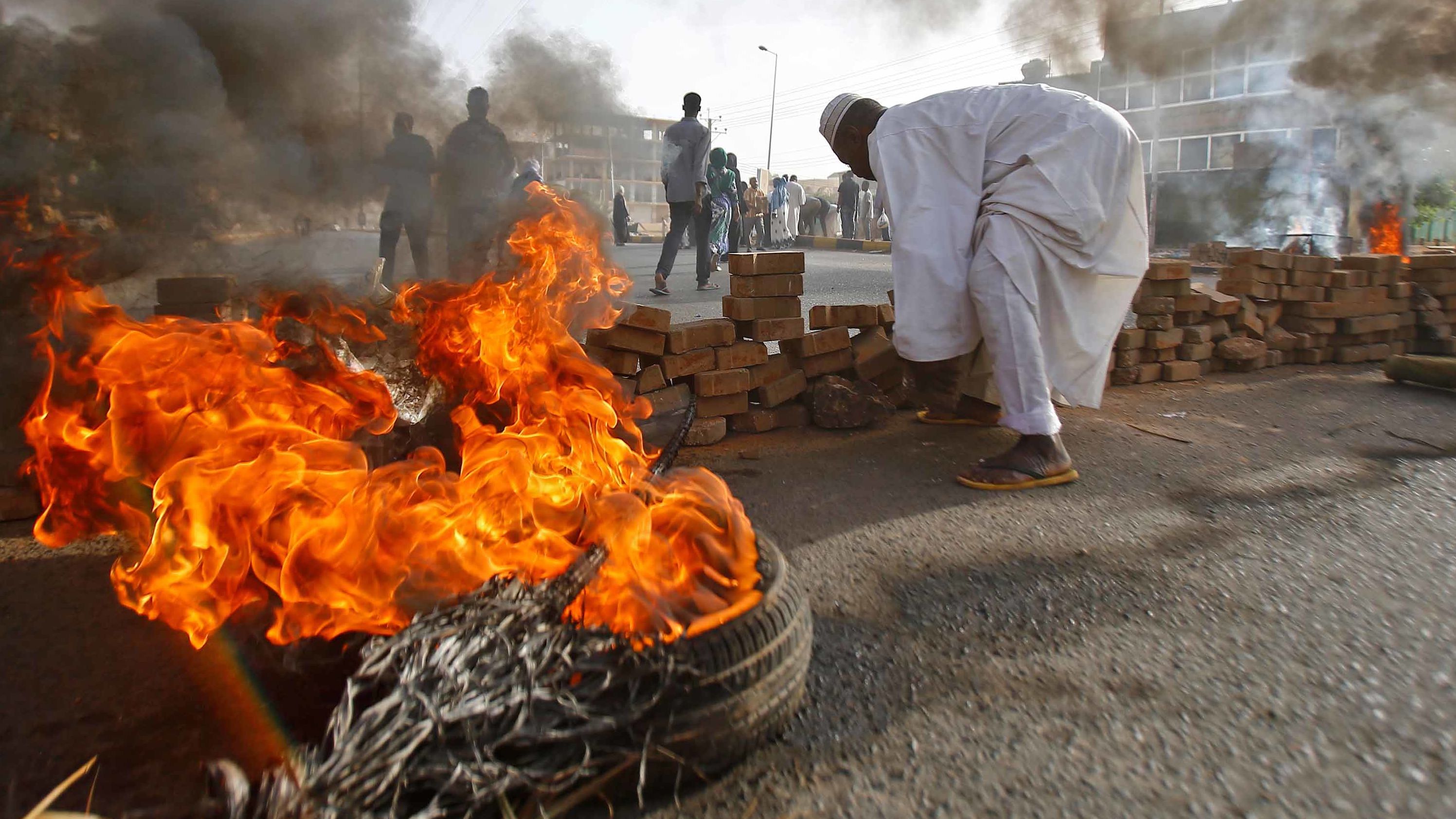 Protesters block a street with bricks and burning tires as military forces attempt to disperse a sit-in outside the army headquarters in Khartoum, Sudan, on Monday, June 3. More than <a href="https://edition.cnn.com/2019/06/05/africa/sudan-death-toll-intl/index.html" target="_blank">100 protesters were killed</a> when the military opened fire to break up the sit-in, according to a local doctors' union.
