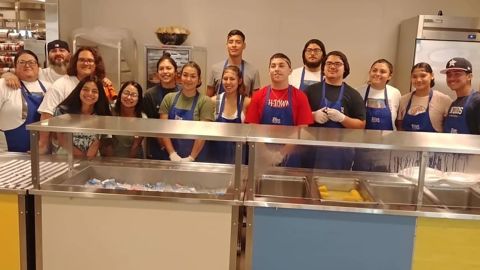 Leanne Carrasco and her friends pose after serving pizza to some 200 homeless women and children.