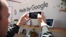 A man takes a photo of new Google products on display during the Google I/O conference at Shoreline Amphitheatre in Mountain View, California on May 7, 2019. (Photo by Josh Edelson / AFP)        (Photo credit should read JOSH EDELSON/AFP/Getty Images)