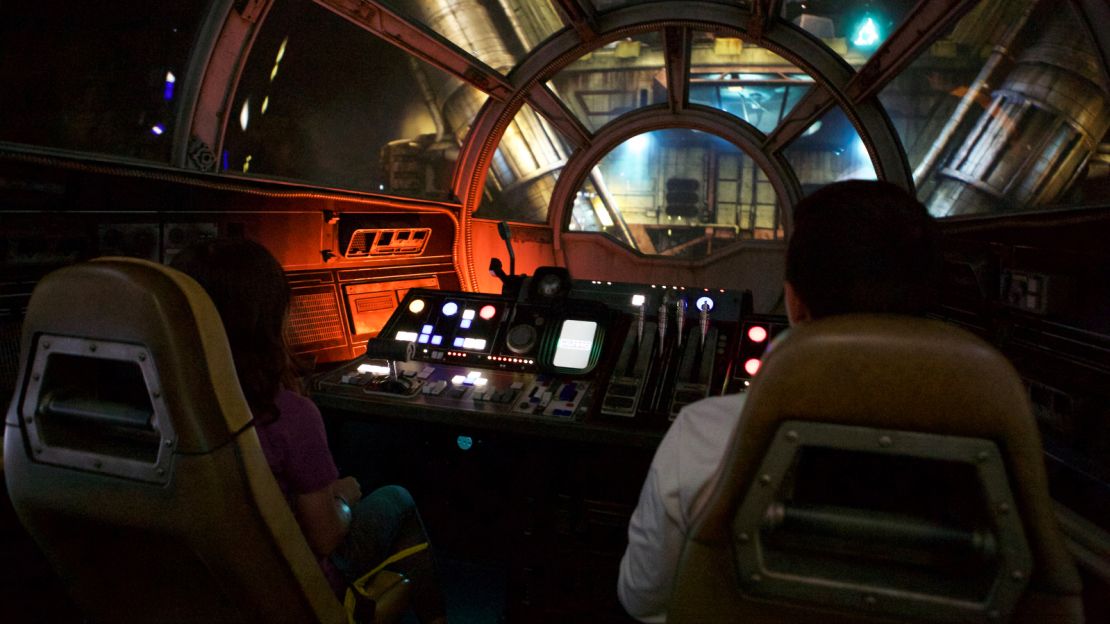 The author's daughter (left) pilots the "fastest hunk of junk in the galaxy" on the Smuggler's Run ride.