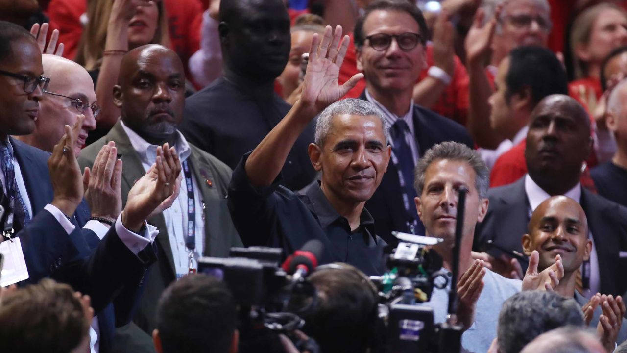 Former President Barack Obama waves to the crowd during Game 2 of the NBA Finals Sunday night.