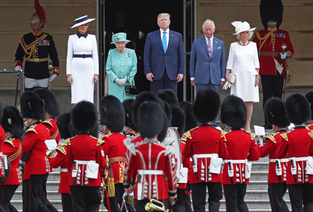The US National Anthem is played during a welcoming ceremony at Buckingham Palace. From left are Melania Trump, the Queen, Trump, Charles and Camilla.