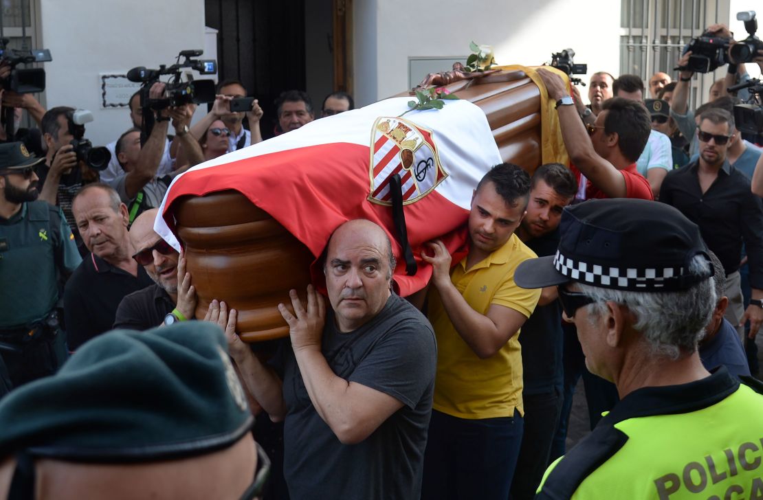 Reyes' coffin, covered with the flags of the village of Utrera and Sevilla FC, was carried through his hometown.