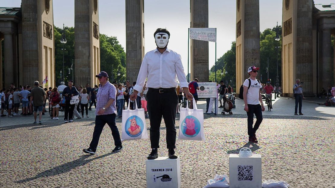 Badiucao takes part in a recreation of the iconic "Tank Man" photo from the Tiananmen Square protests of June 1989.