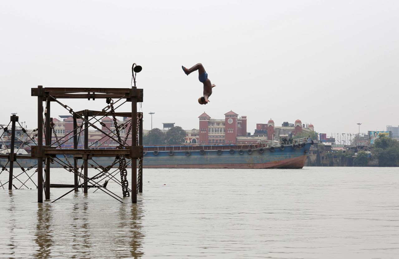 A boy jumps into the Ganges River to cool off on a hot summer day in Kolkata, India, on Monday, June 3. 