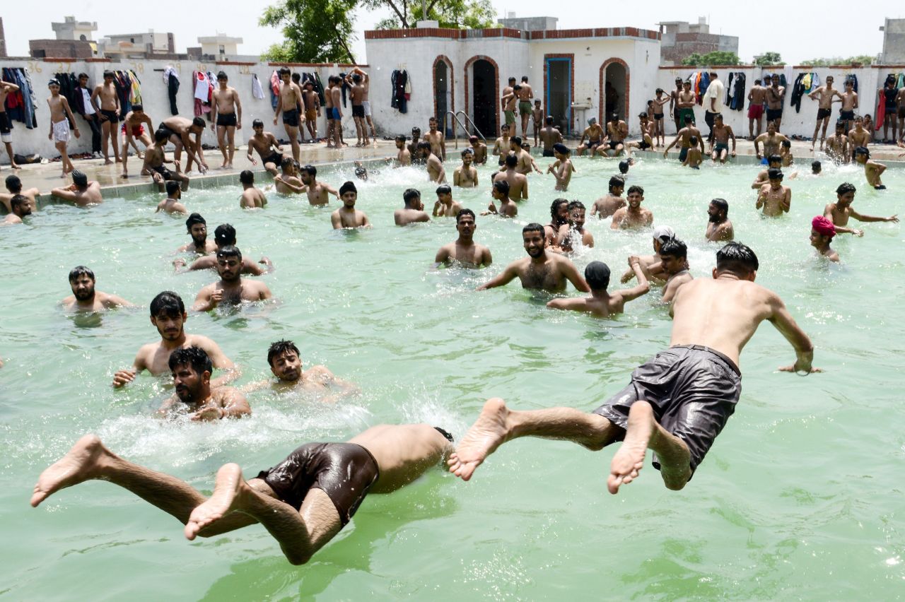 Indian youths play in a swimming pool on a hot summer day on the outskirts of Amritsar on June 2.