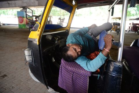 An Indian auto driver rests under a bridge on a hot summer afternoon in Allahabad on Sunday, June 2.