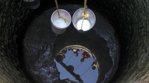 Indian villagers take buckets down a well running dry to collect drinking water at Padal village of the district of Samba, some 45 kilometers from Jammu, on Sunday, June 2. A heatwave triggered warnings of water shortages and heatstroke.