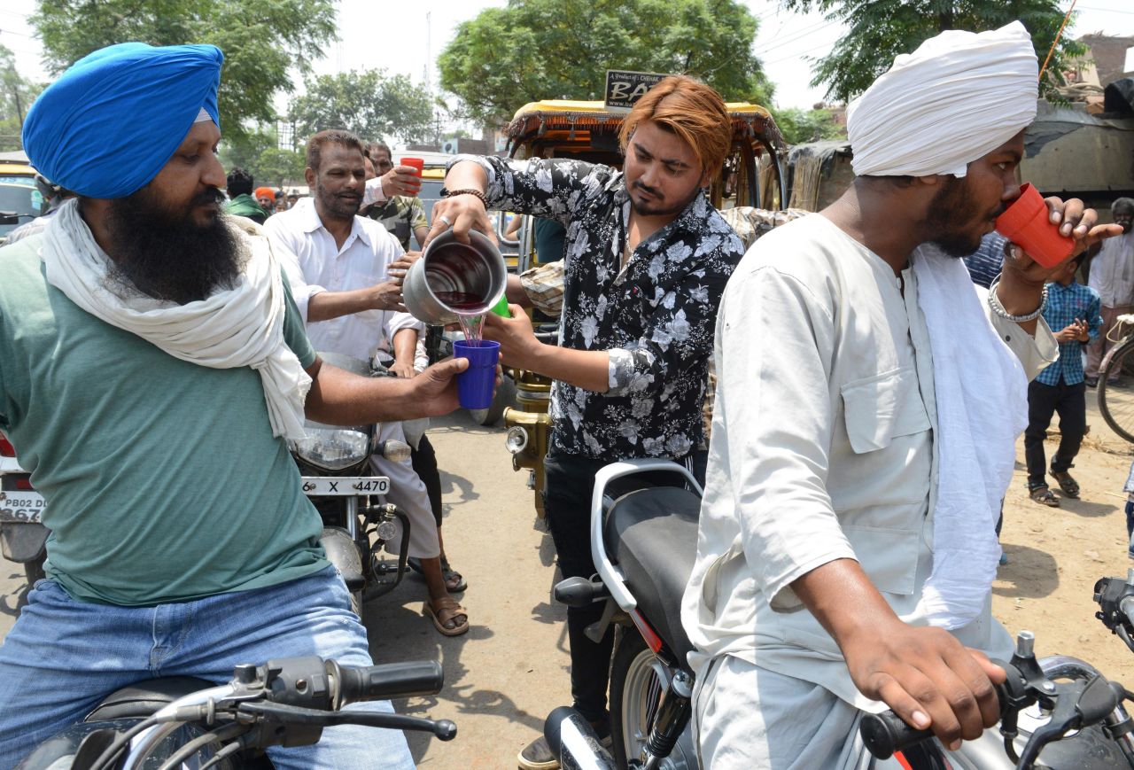Indian volunteers distribute sweet water during a hot summer day, in Amritsar on Sunday, June 2.