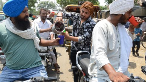Indian volunteers distribute sweet water during a hot summer day, in Amritsar on Sunday, June 2.