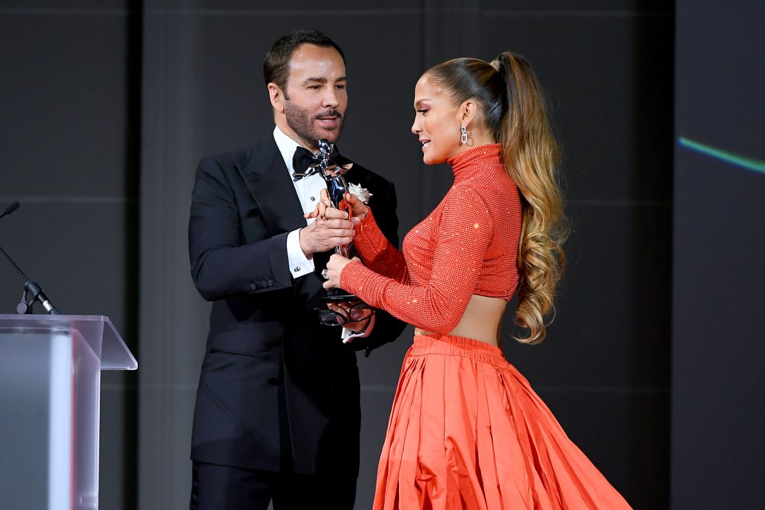 Jennifer Lopez and Tom Ford appear onstage at the CFDA Fashion Awards.