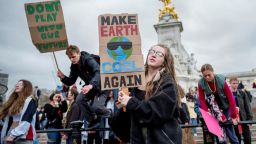 Young demonstrators leave from the Queen Victoria Memorial as they take part in the "Global Strike 4 Climate" protest march, outside of Buckingham Palace in central London on March 15, 2019. 