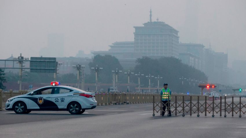 A traffic warden and police vehicle block the road towards Tiananmen Square during flag raising on the 30th anniversary of a bloody crackdown of pro-democracy protesters in Beijing on Tuesday, June 4, 2019. Critics say the 1989 Tiananmen crackdown, which left hundreds, possibly thousands, dead, set the ruling Communist Party on its present course of ruthless suppression, summary incarceration and the frequent use of violence against opponents in the name of "stability maintenance." (AP Photo/Ng Han Guan)