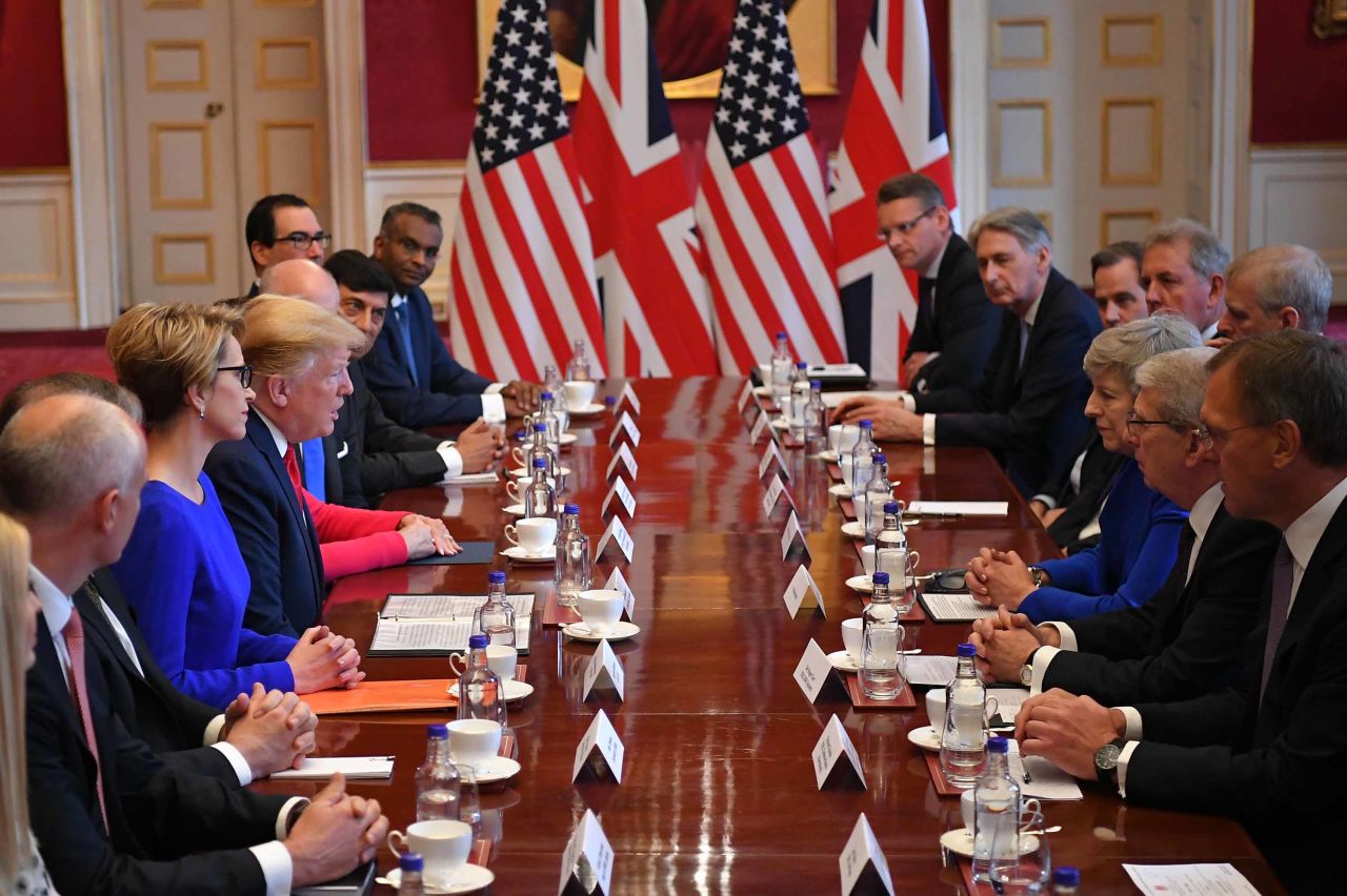 Trump speaks opposite May at a business roundtable discussion in London.