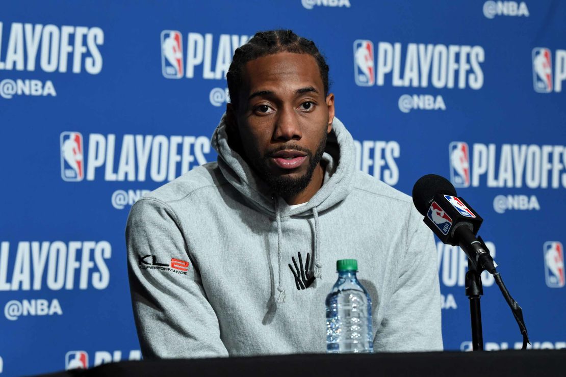 Leonard, wearing a hoodie featuring the logo in dispute, speaks with the media in May.